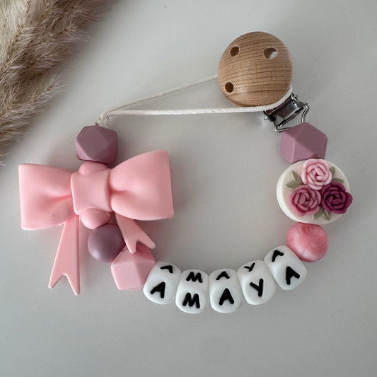 Speenkoord met naam roosjes / strik / roze