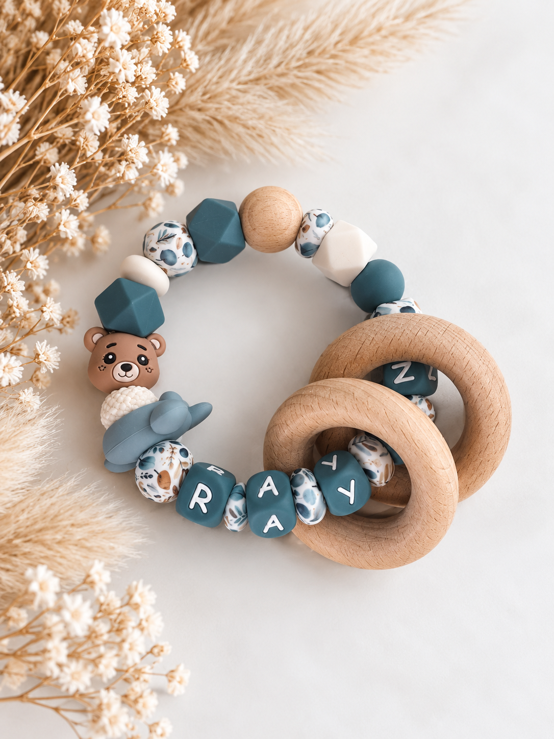 Bijtring met naam beertje / vliegtuig / blauw